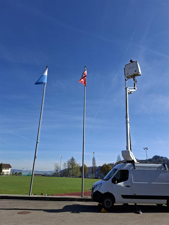 Aerial work platform next to flagpoles