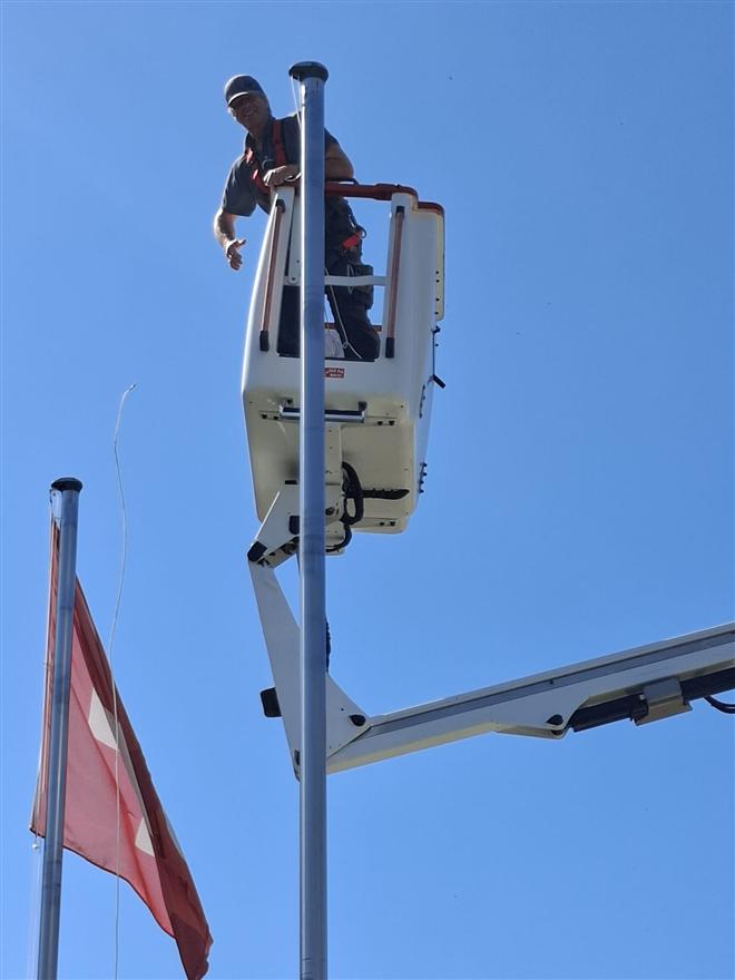Technician working on a flagpole